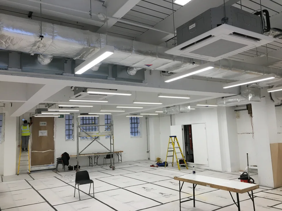 Ceiling cassettes and ductwork during installation.
