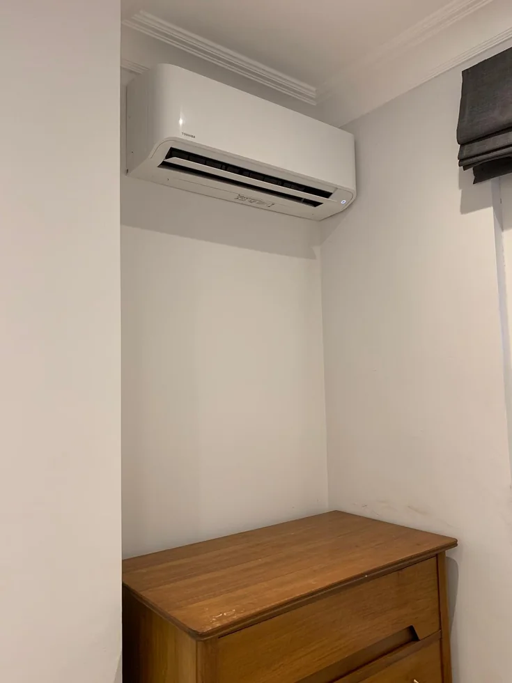 Wall-mounted air conditioning in a home room.